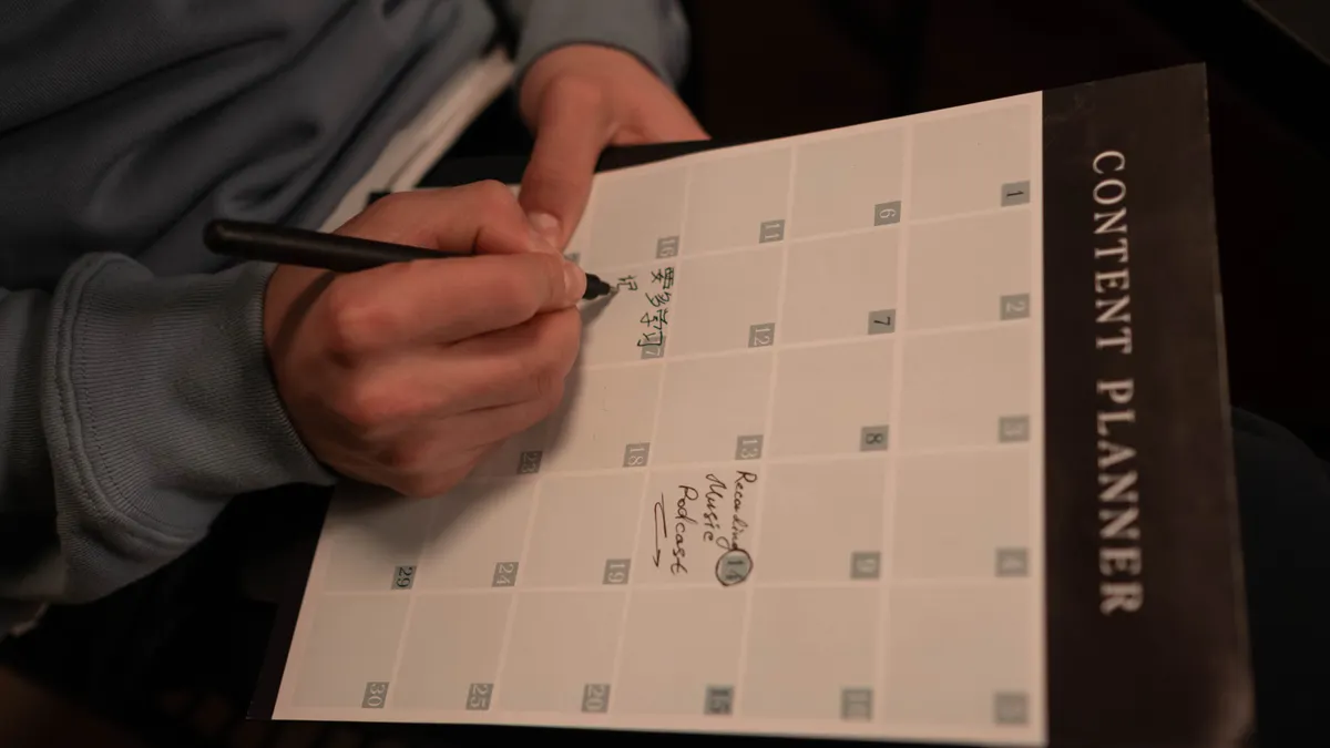 Hand writing in a content planner calendar