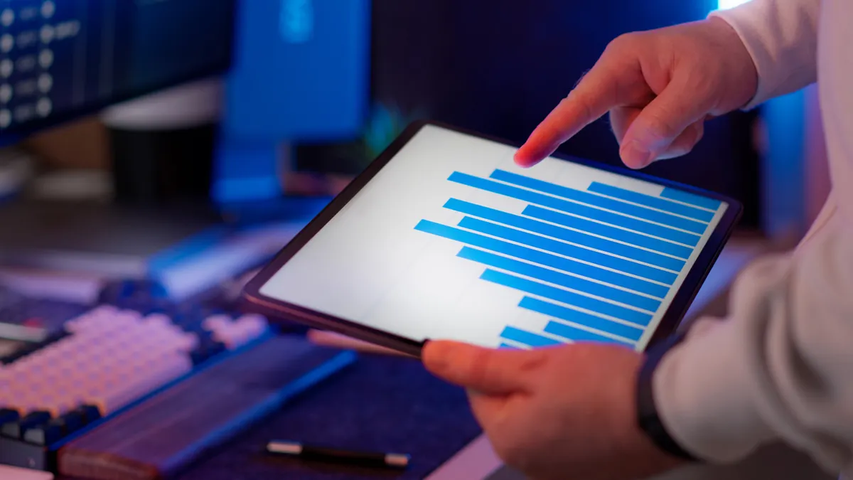 How to choose the right pages to refresh before creating new content hands holding a tablet with a bar chart