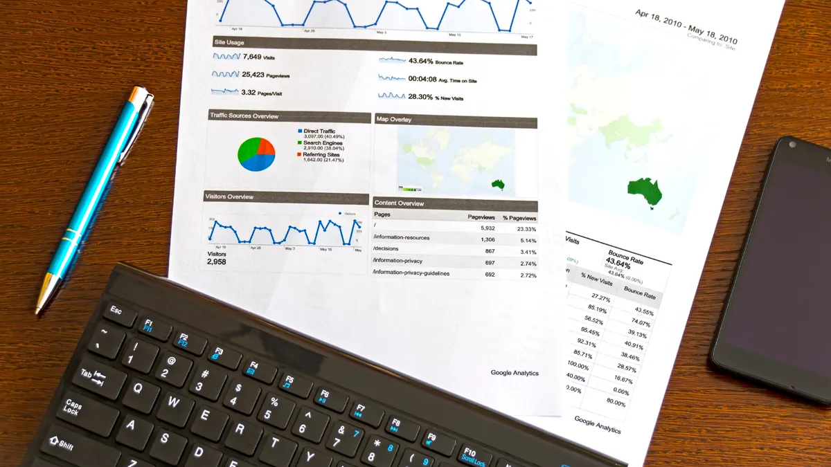 printed analytics reports on a desk with charts and graphs