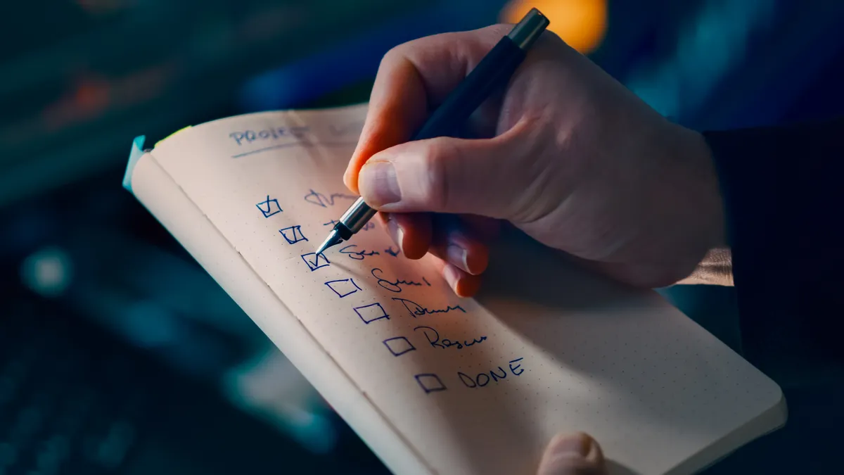 How to update content when competitors add missing subtopics hand ticking off a checklist in a notebook
