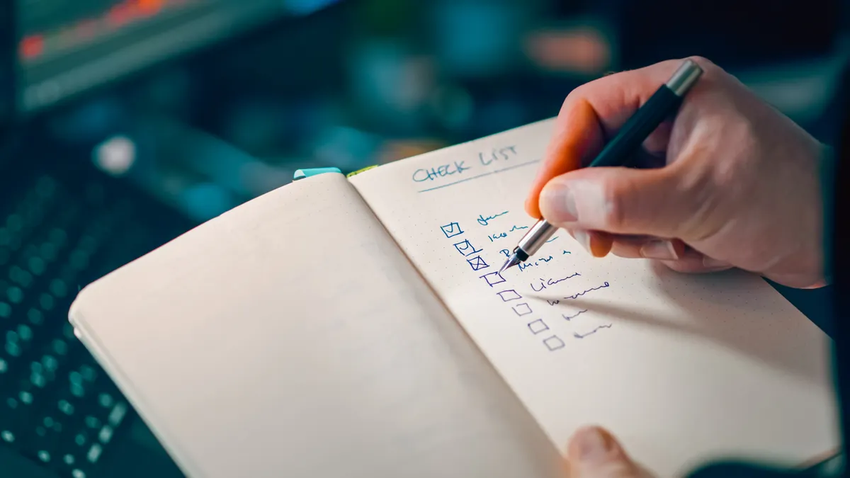 How to update content when competitors add missing subtopics hand checking items off a notebook checklist