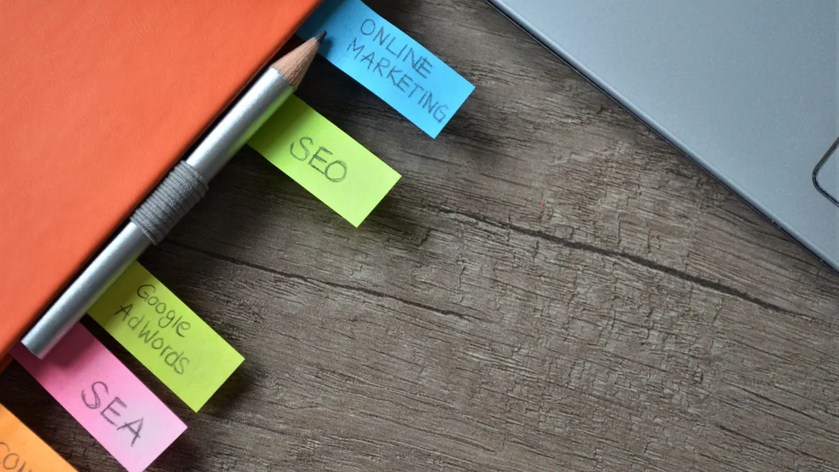 How to use AI to plan a content hub and spoke structure Sticky notes for SEO and online marketing beside a laptop