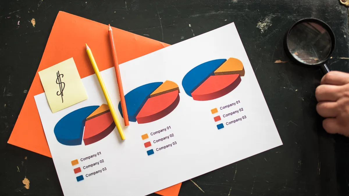 comparison charts on paper with a magnifying glass