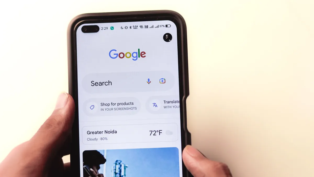 What makes a page outrank a competitor in search results — Men typing in the Google search engine from realme 6 pro. "Go